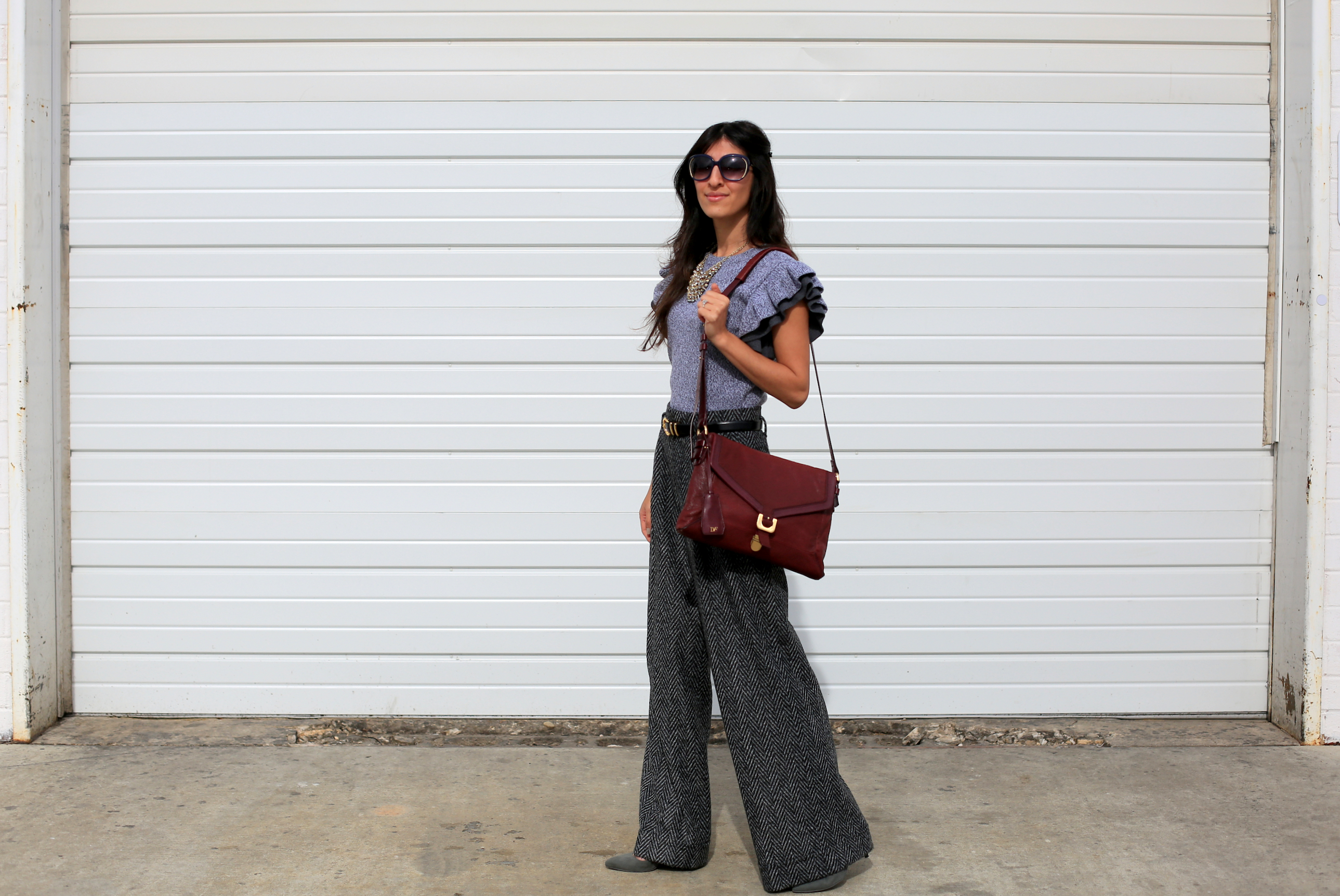 How to balance your girly side with minimalist chic? Add a flirty feminine piece like this flutter-sleeve sweater in a neutral color to an otherwise masculine outfit to tone it down!