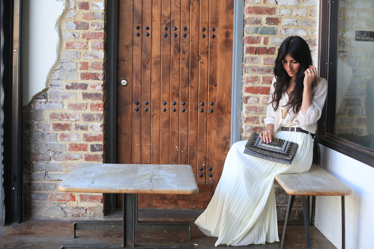 white skirt outfit sitting down outside la colombe