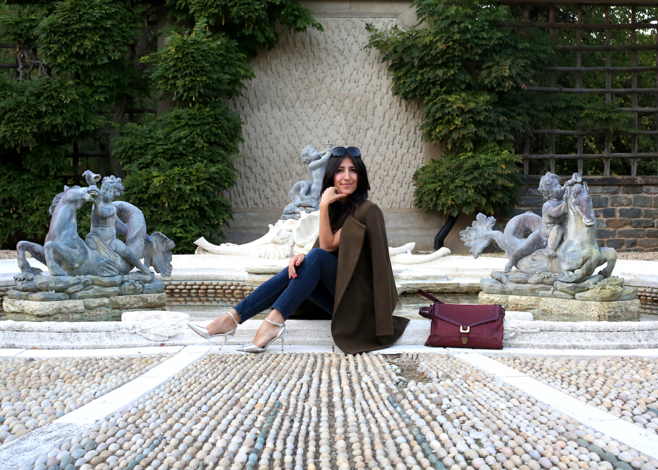 dumbarton-oaks-pebble-garden-fountain-theory-jacket-sitting-smiling